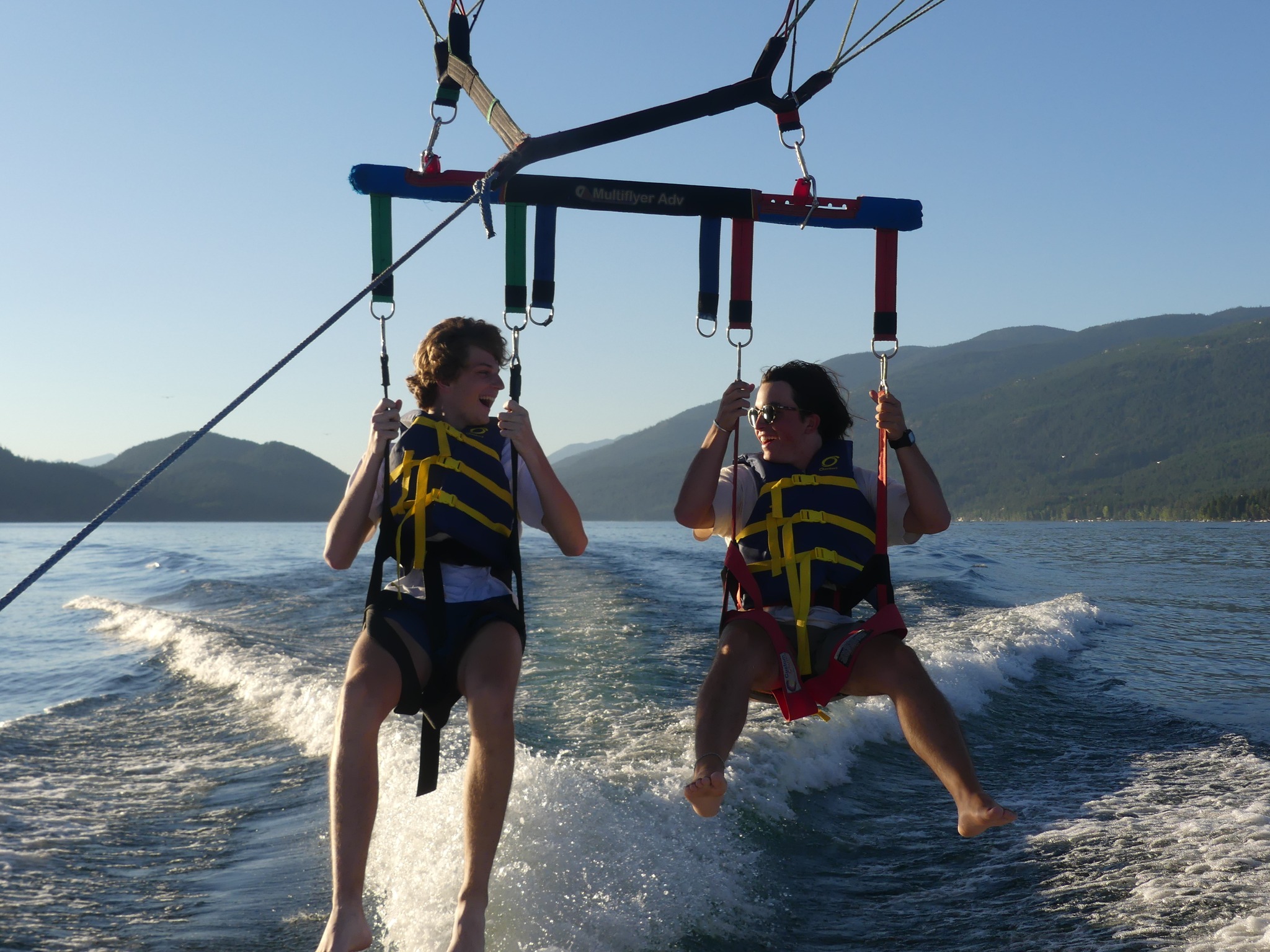 Smiling parasailers over Flathead Lake